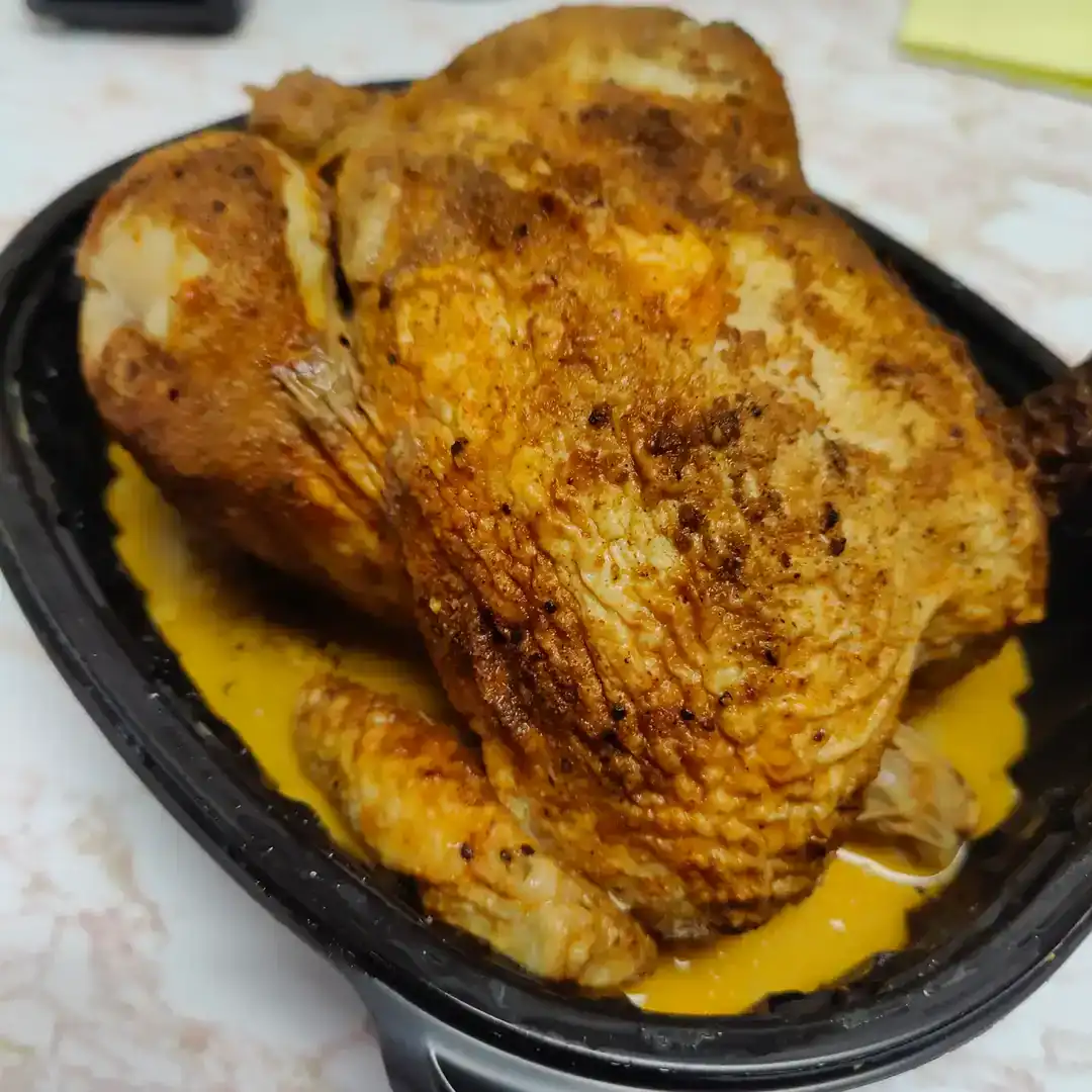 Crispy, flavorful fried chicken served in a black dish, perfect for a hearty meal or family dinner.