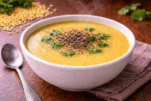 Hot moong dal soup served in a bowl
