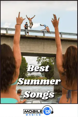 People enjoying summer music festival with hands in the air and performers on bridge.