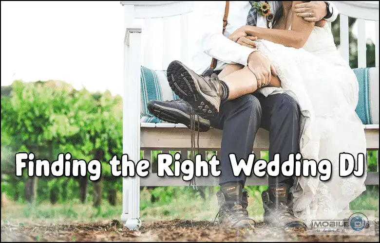 Wedding couple sitting on a bench with DJ equipment at outdoor wedding venue.
