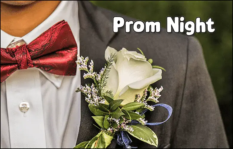 Close-up of a groom's tuxedo with a white rose boutonniere for prom night.
