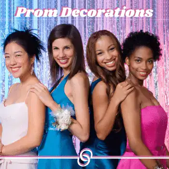 Group of four women in colorful dresses celebrating at prom event.