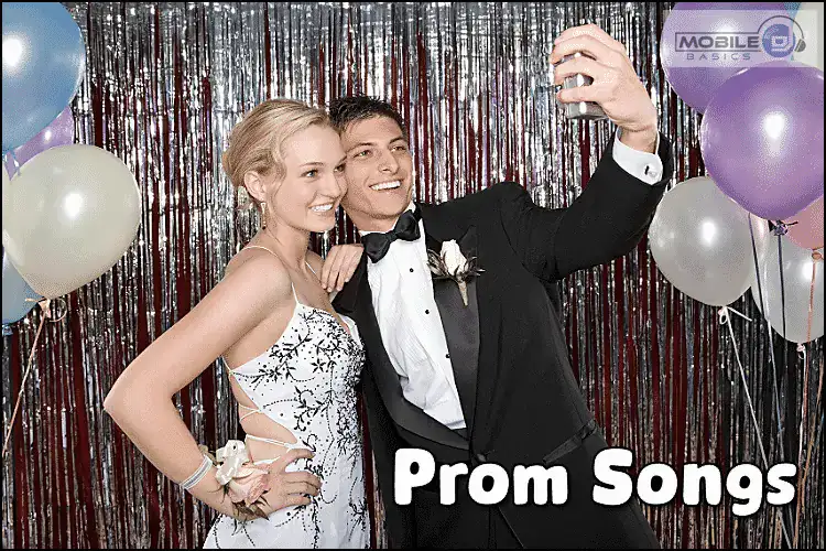 Young couple taking a selfie at prom with balloons and festive backdrop.