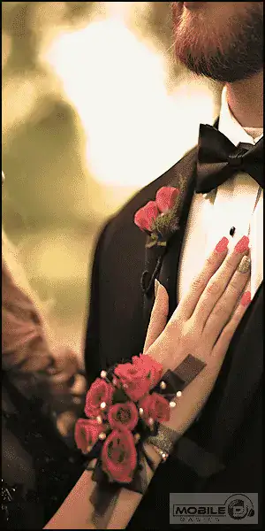 Close-up of a bride and groom at a wedding, focusing on their hands and attire.