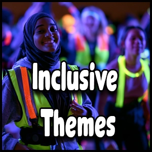 A group of people wearing reflective vests stand together; “Inclusive Themes” is written in bold white text over the image, highlighting the importance of accessible dance themes and diverse school events.