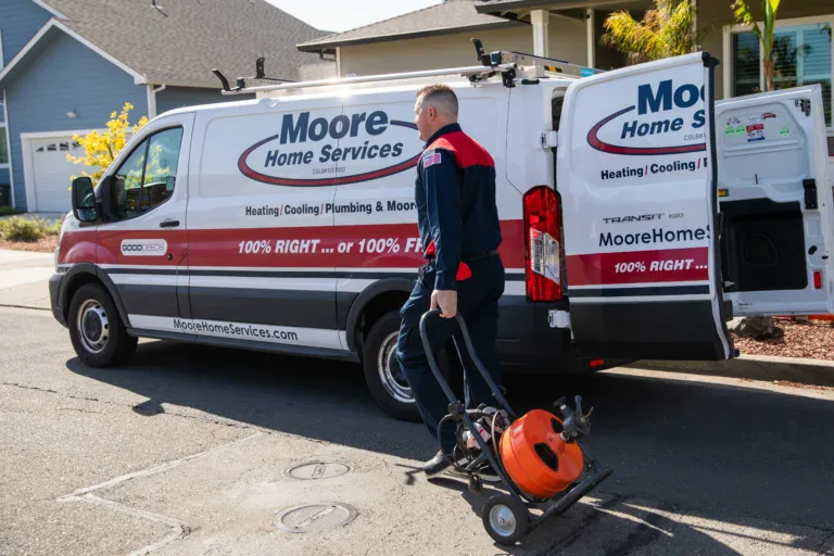 A Moore Home Services technician arrives with drain cleaning gear, ready to deliver guaranteed, spotless plumbing service you can trust.
