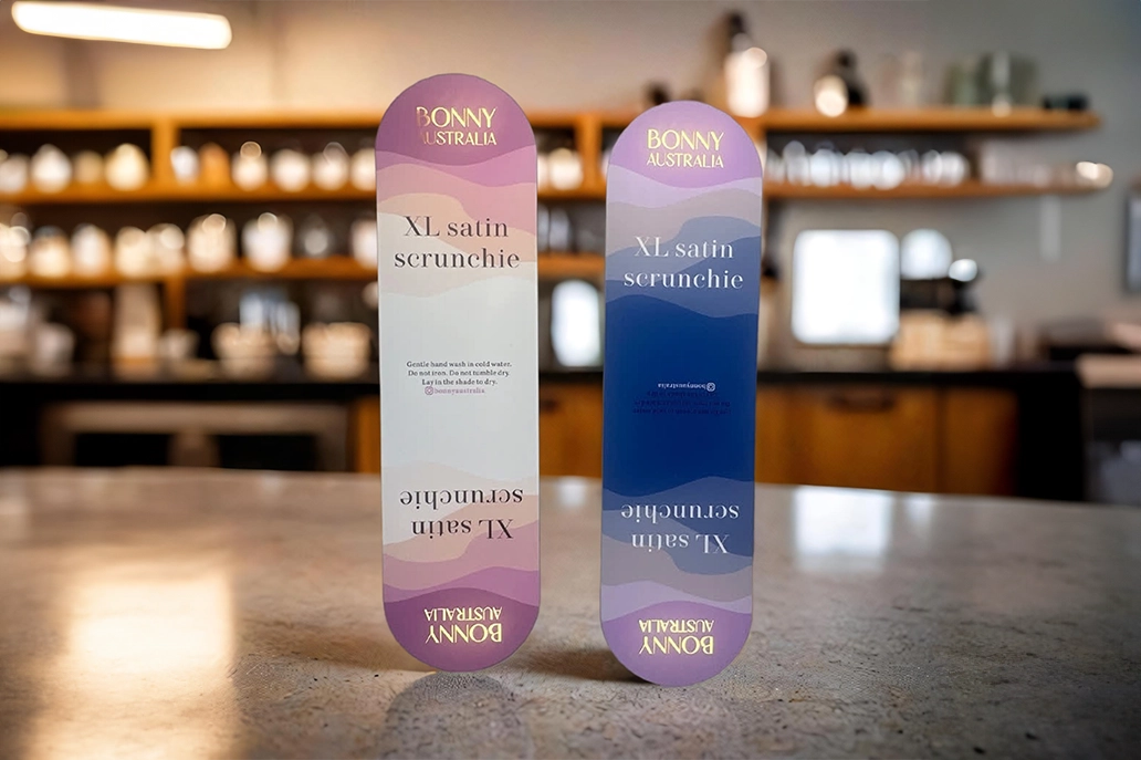 Custom shaped oblong marketing cards with gold foiling
