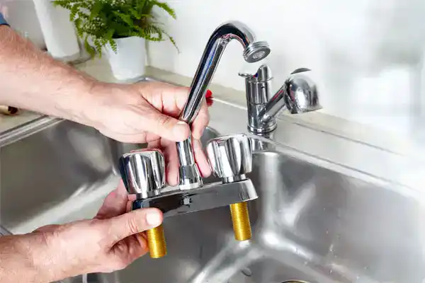 A Service Champions expert prepares to install a new kitchen faucet, ensuring dependable and caring service for your home’s comfort.