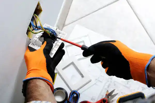 A trusted Service Champions expert carefully installs an electrical outlet, ensuring safe, reliable comfort for your Southern California home.