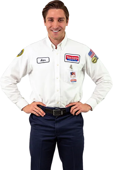 Adam, your friendly local Service Champions expert, stands ready in uniform with a warm smile, here to serve your home needs.