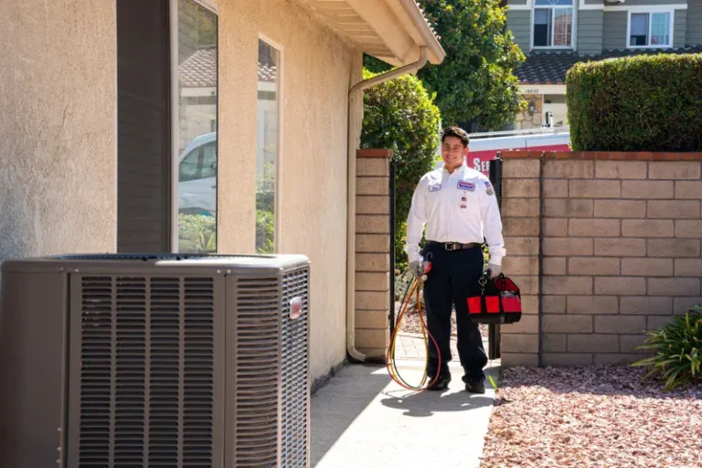 A trusted Service Champions technician approaches a home's outdoor A/C unit, ready to provide reliable, caring service.
