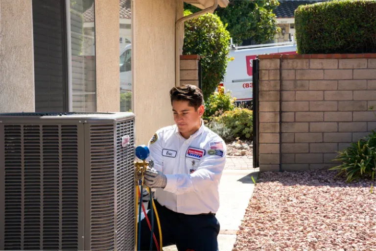 A friendly Service Champions technician checks AC gauges on a home unit in Brea, CA, providing trusted comfort on a sunny day.