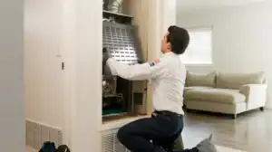 A trusted technician in uniform carefully inspects a home furnace in Brea, CA, delivering reliable comfort and expert care.