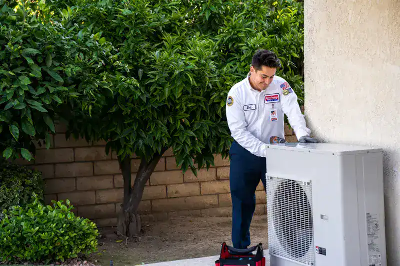 A Service Champions technician inspects a home heat pump in Brea, CA, delivering trusted, expert comfort care to local families.