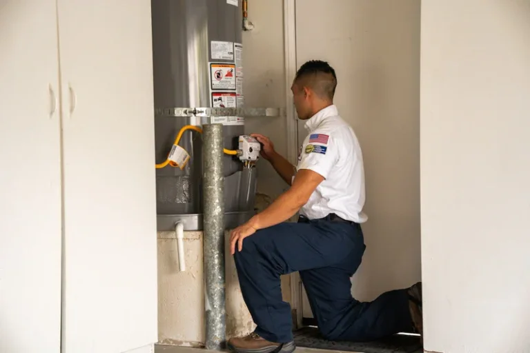 A caring Service Champions technician checks a home water heater in Brea, CA, delivering trusted comfort and plumbing expertise.