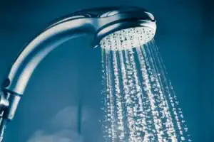 Close-up of a showerhead with streaming water, representing Service Champions’ trusted tankless water heater repair in Brea, CA.