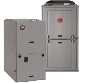 Two reliable gray Rheem gas furnaces stand side by side, offering dependable comfort from your trusted local Service Champions team.