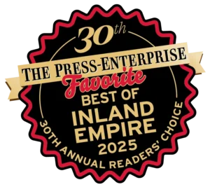 A gold and black badge with red highlights honors Service Champions as a trusted, customer-first home comfort expert in Inland Empire.