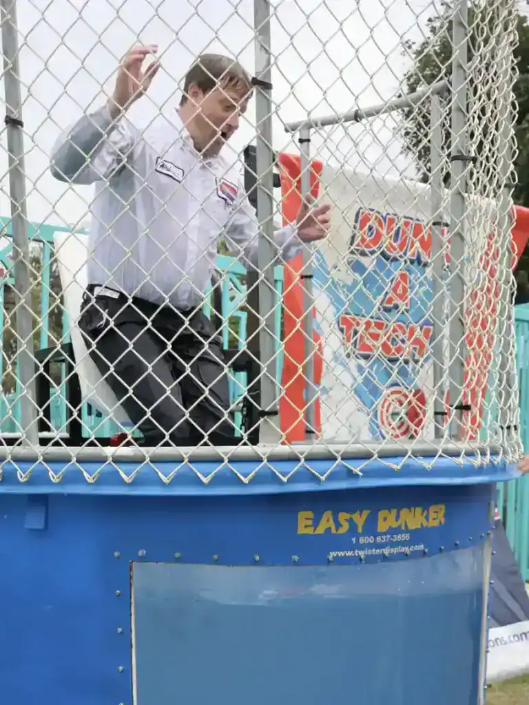 At the Brea Country Fair, a Service Champions technician stands inside a dunk tank, ready to bring smiles and community spirit as part of the Fourth of July festivities. The tank, enclosed in netting with a “Dunk A Tech” sign, showcases Service Champions’ dedication to local engagement and their dependable commitment to keeping Southern California homes comfortable—always putting customers first with trustworthy HVAC, plumbing, and drain expertise.