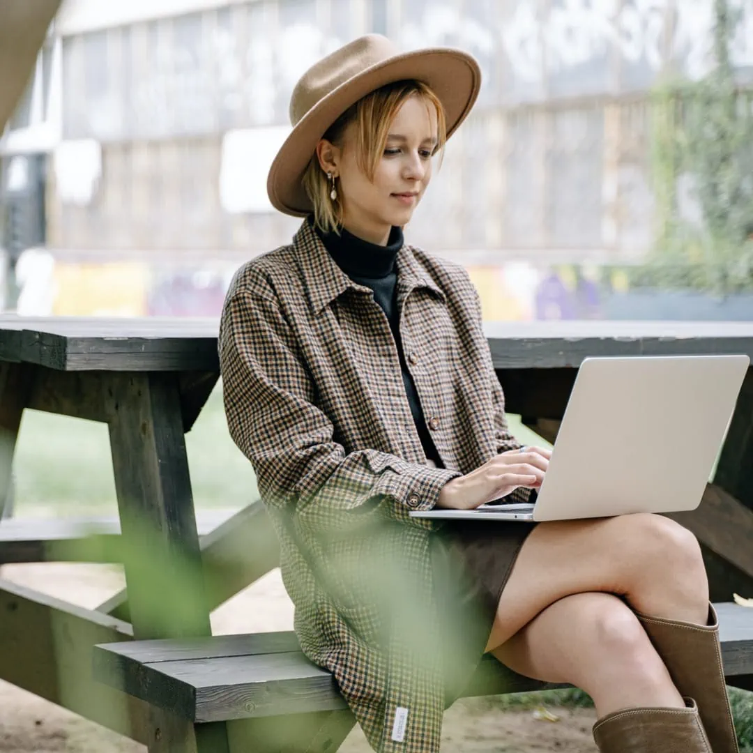 Woman working on laptop outside