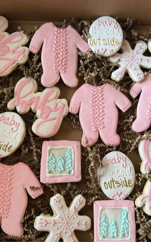 Decorative baby shower cookies with pink, blue, and white themes from Smutz Girls Bakery.