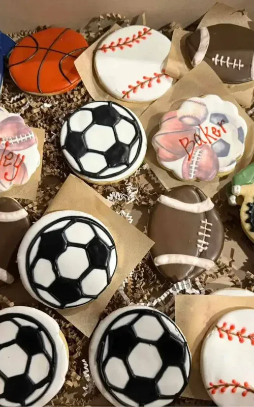 Decorative sports-themed cookies including football, basketball, and soccer balls.