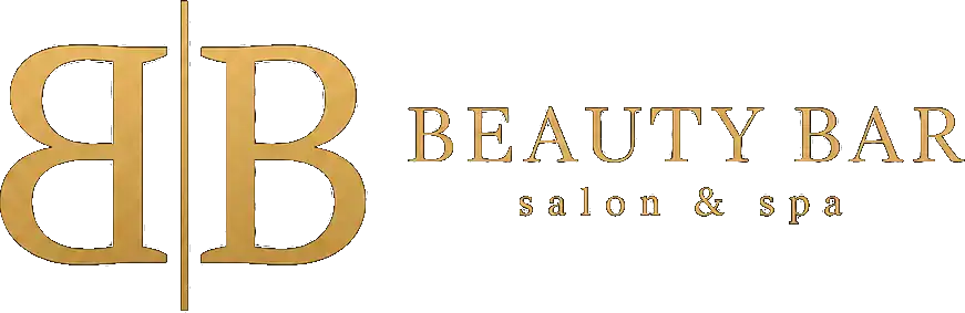 Beauty Bar & Spa logo and storefront signage in elegant gold and black design.