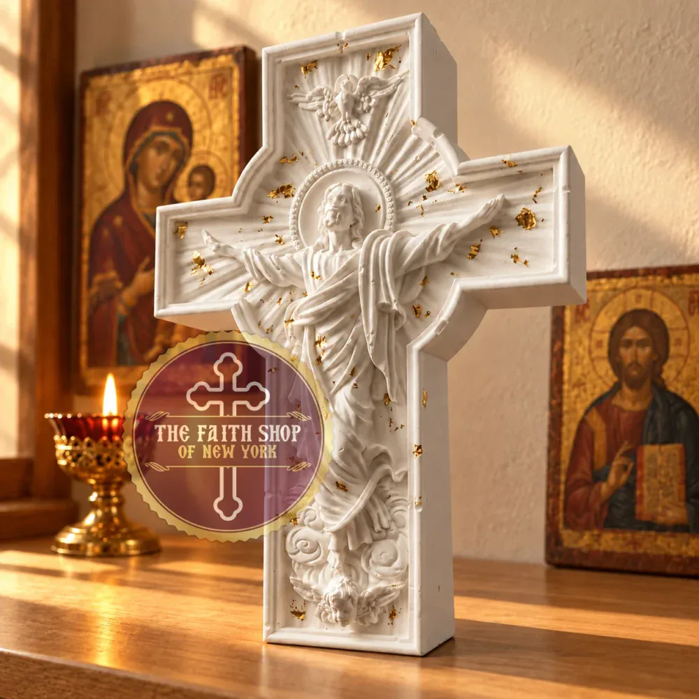 The Resurrection Standing Cross, beautifully cast in ceramic resin with gold leaf accents for home altars and sacred spaces. Handcrafted white ceramic resin Resurrection Standing Cross with gold leaf details displayed on a wooden surface next to traditional icons and a lit candle.