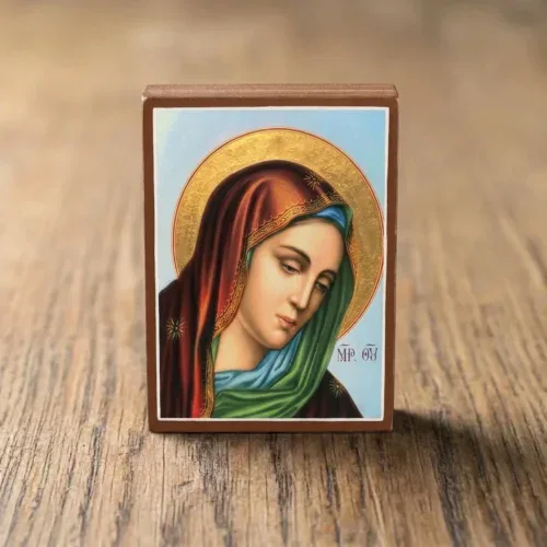 Handcrafted wooden Orthodox icon of the Sorrowful Mother of God (Panagia Thlimmeni) featuring the Virgin Mary weeping with a gold leaf halo on a light wooden background.