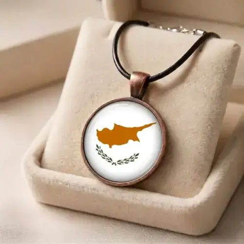 Round Cyprus flag pendant necklace with glass cabochon presented inside a soft beige jewelry gift box.