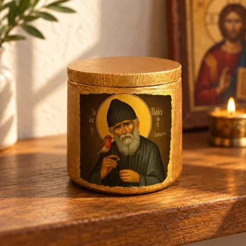 Saint Paisios Ceramic Keepsake Jar with Lid sitting on a wooden home prayer altar next to a candle and Christ icon