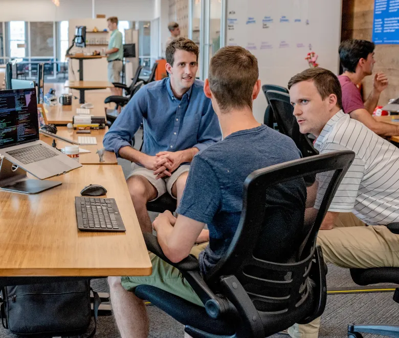 Group of coworkers chatting in an office