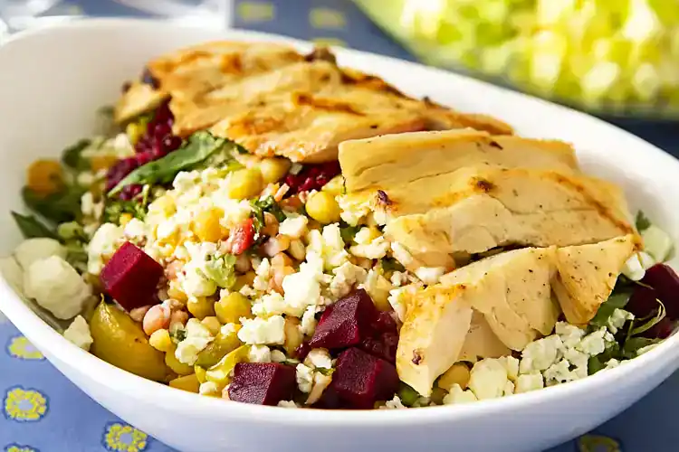 Healthy Mediterranean grain bowl with grilled chicken and fresh vegetables.