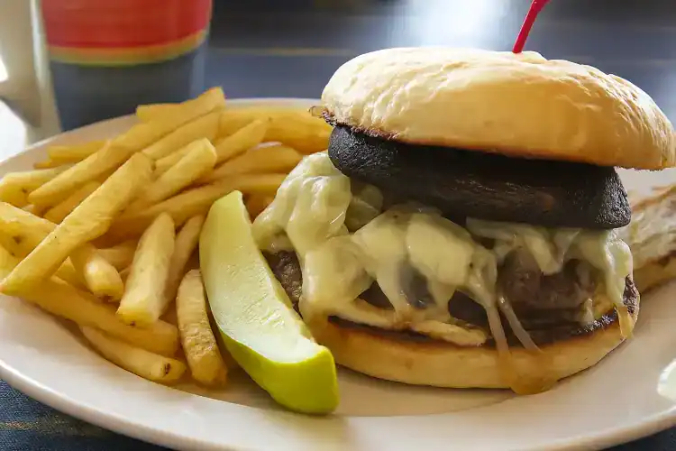 Delicious mushroom burger with fries and lime wedge at Village Baker.