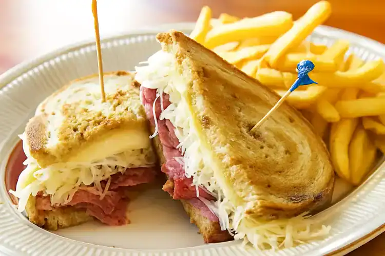 Delicious Reuben sandwich with corned beef, sauerkraut, and melted cheese.