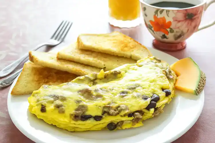 Southwestern omelette with black beans, cheese, and peppers on a plate.