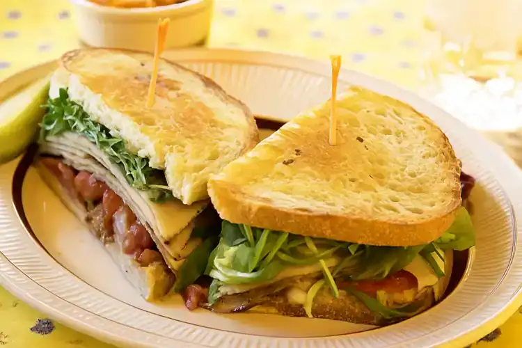 Delicious turkey bacon bruschetta on toasted bread with fresh greens.