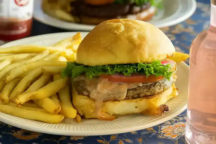 Delicious veggie black bean burger with lettuce, tomato, and cheese on a bun.