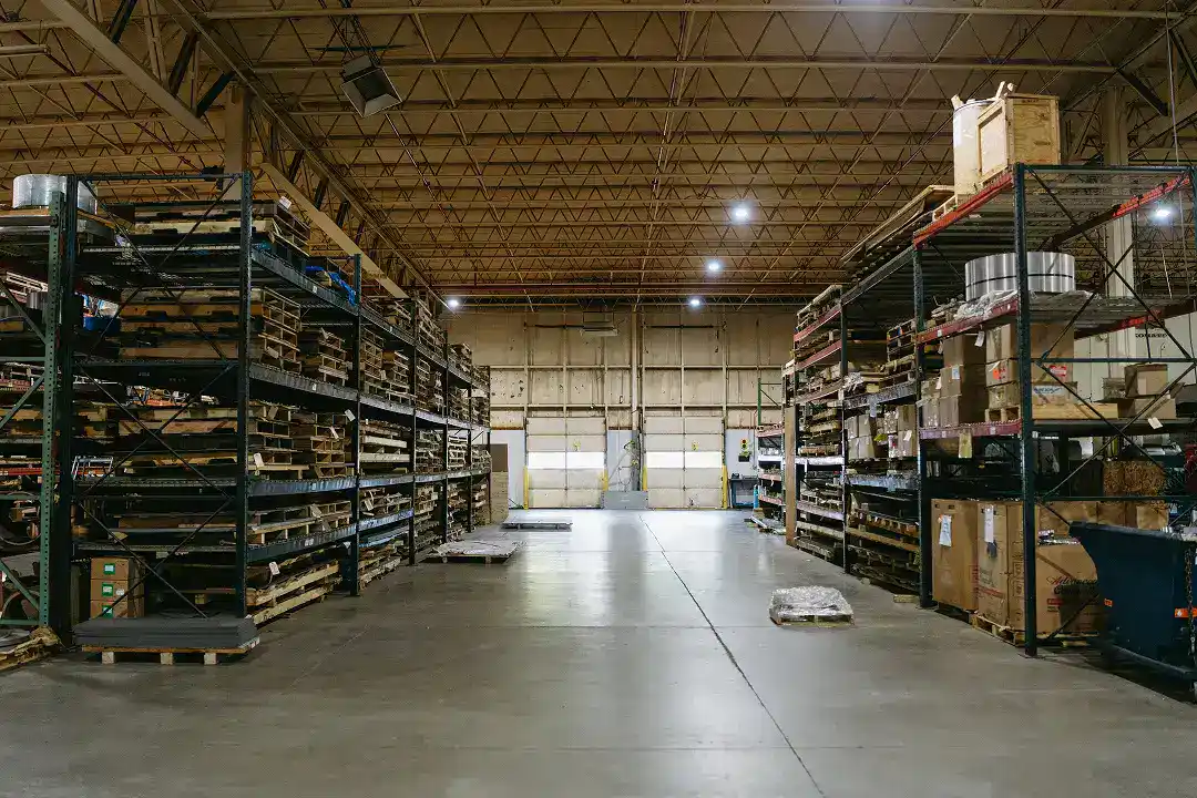 Industrial warehouse with metal shelves and stored manufacturing parts.