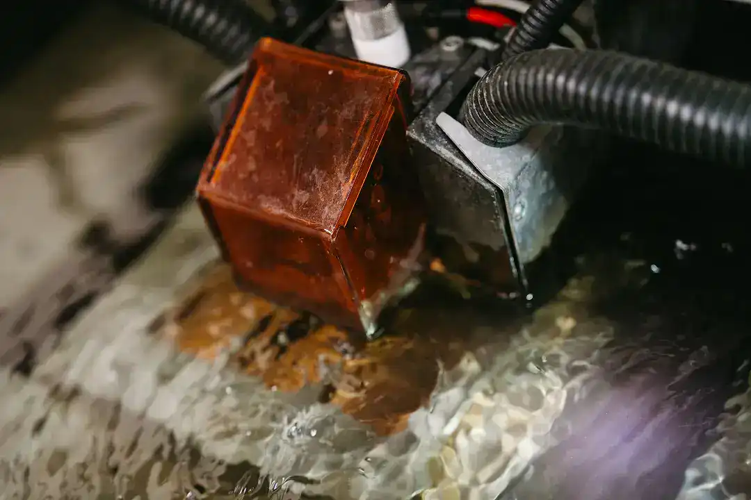 Close-up of industrial electrical component with wiring and water splash.
