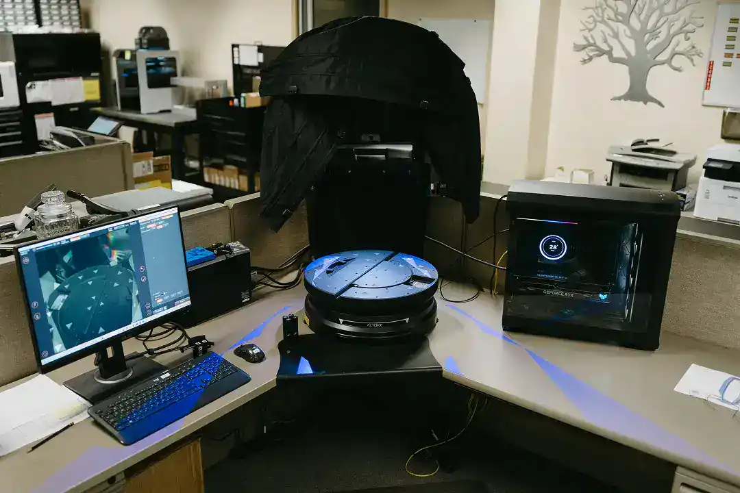 Robotic vacuum cleaner in an office environment with computers and equipment.