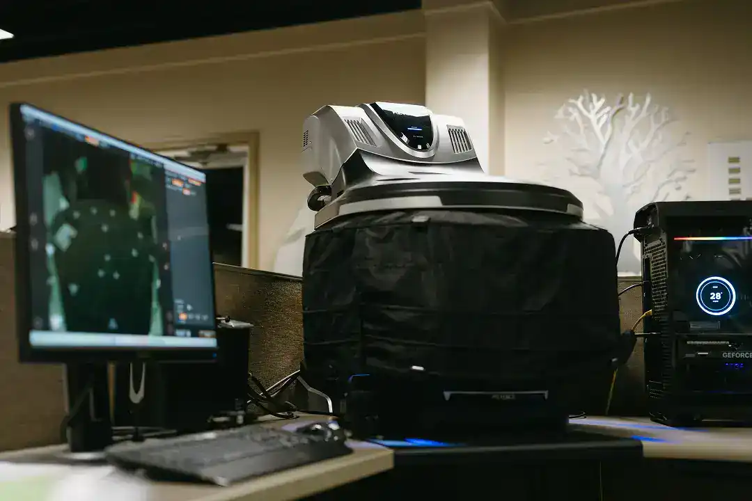 Advanced industrial 3D scanner on a desk in a manufacturing facility.