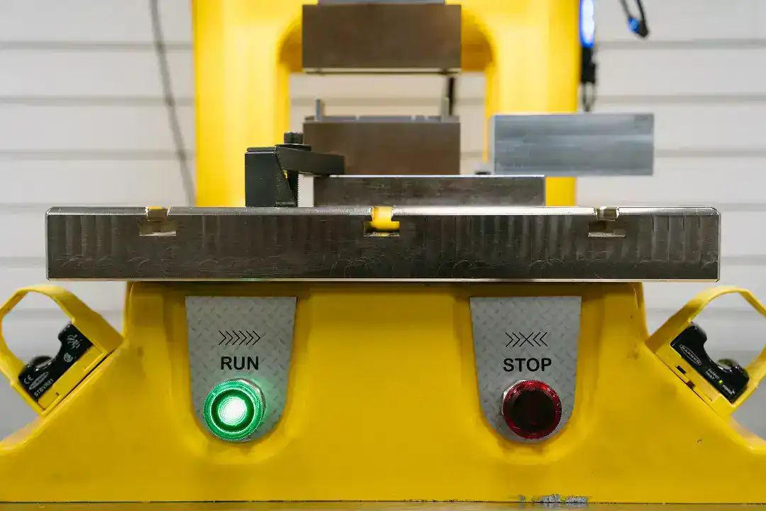 Industrial robotic machine with run and stop buttons at Active Manufacturing.