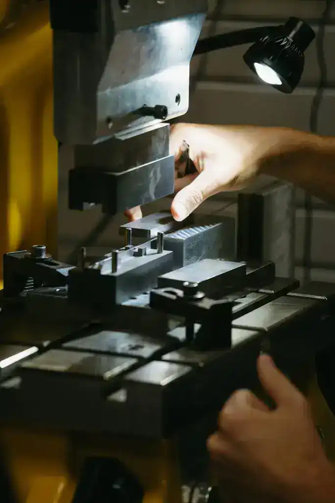 Precision machining process with a metal workpiece under a machine tool.
