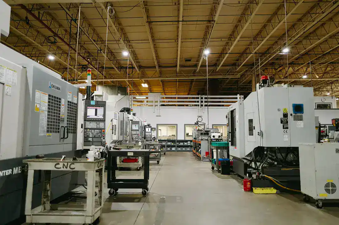 Industrial manufacturing facility with CNC machines and automation equipment.