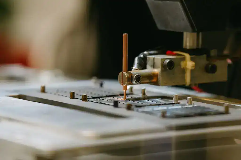 Precision manufacturing process with CNC machine and metal components.