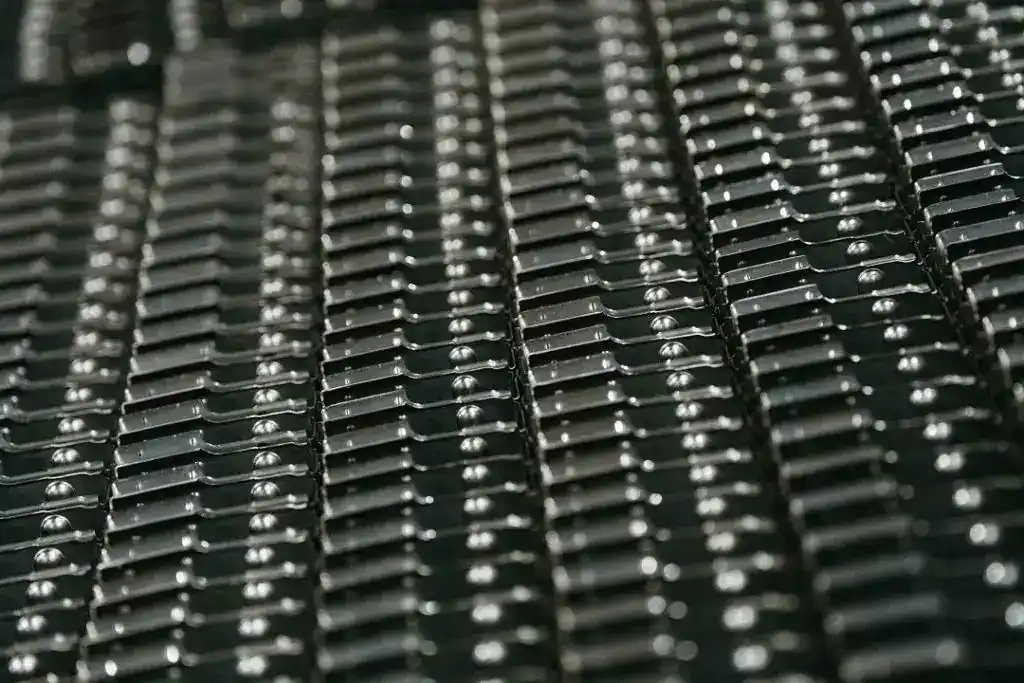 Close-up of black metal manufacturing components with precise detailing.