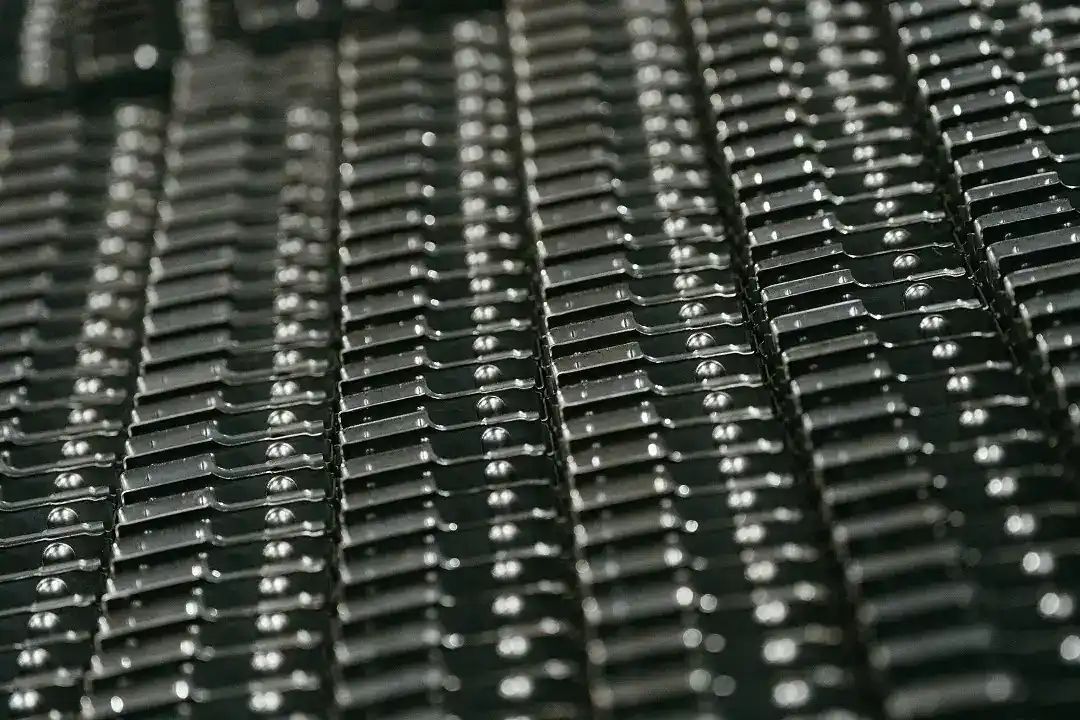 Close-up of black metal manufacturing components with precise detailing.