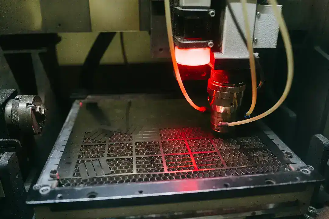 Laser cutting machine processing metal sheet for manufacturing.