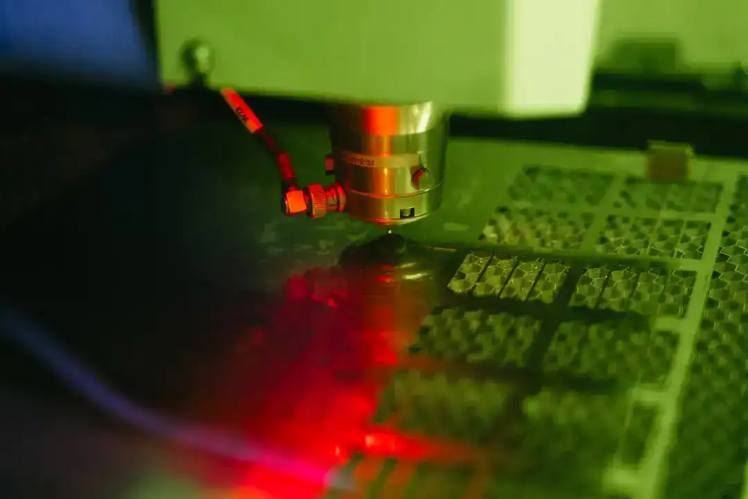 Precision laser cutting process in active manufacturing facility.